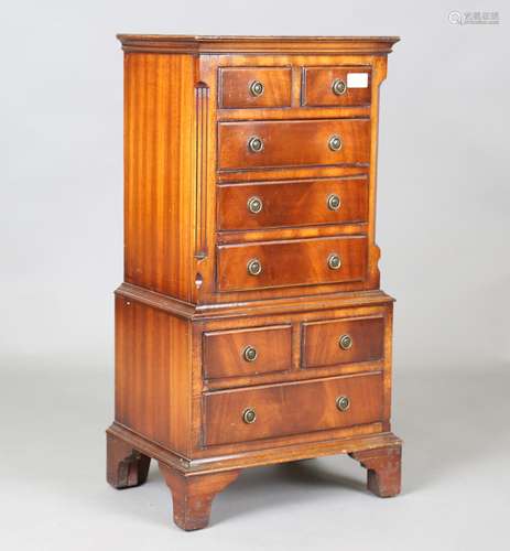 A 20th century reproduction mahogany diminutive chest-on-che...