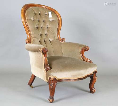 A Victorian walnut showframe armchair with carved S scroll h...