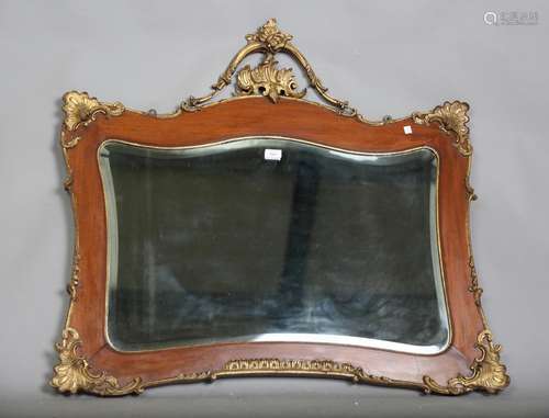 An early 20th century mahogany and gilt composition shaped w...