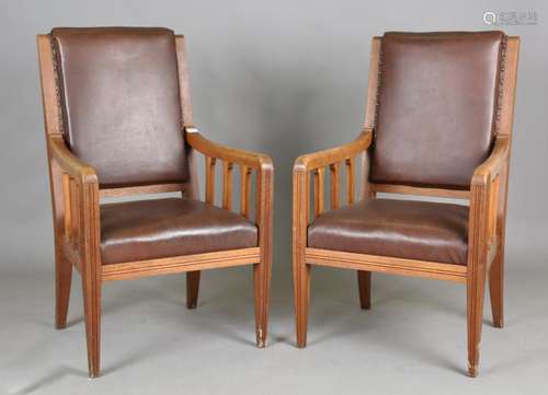 A pair of early 20th century French oak framed elbow chairs ...