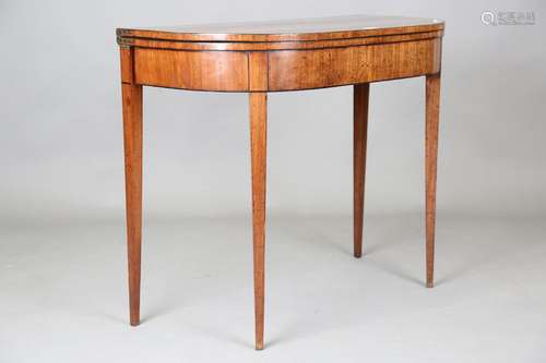 A George III mahogany fold-over card table, the hinged top a...