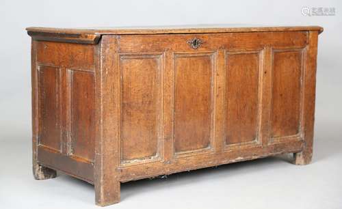 An early 18th century oak panelled coffer, raised on stile s...