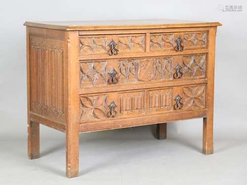 An early 20th century Gothic Revival oak chest of three long...