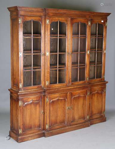 A modern George III style solid oak breakfront bookcase cabi...