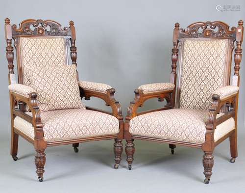 A pair of late Victorian walnut framed armchairs with foliat...