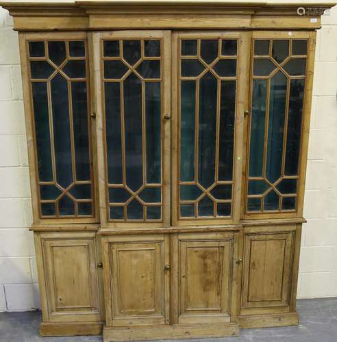 A 20th century George III style pine breakfront bookcase cab...