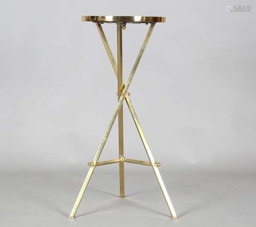 A mid-20th century gilt brass stand, inset with an onyx top,...