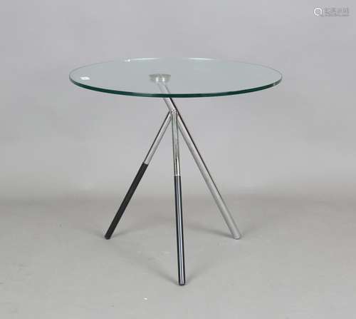 A modern glass and chromium plated tubular metal circular oc...