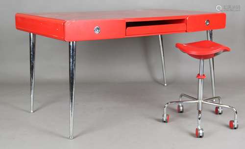 A modern red lacquered writing desk with chromium plated han...