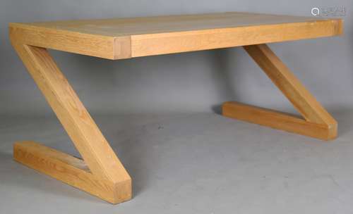 A modern solid oak dining table with Z shaped end supports, ...