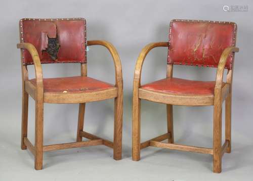 A pair of early 20th century oak framed elbow chairs, attrib...