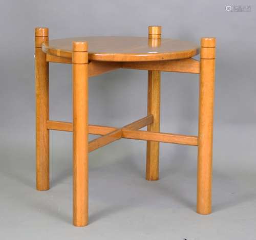 A mid-20th century oak centre table, the circular top and X ...