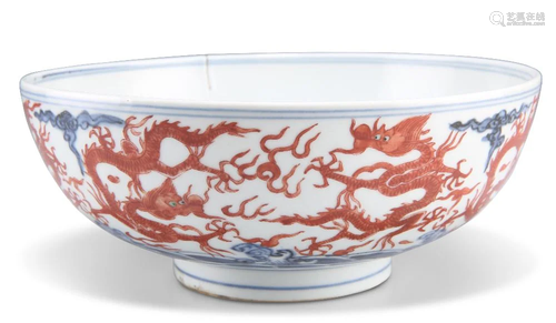 A CHINESE IRON-RED AND UNDERGLAZE BLUE 'DRAGON' BO...