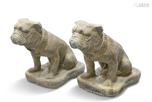 A PAIR OF RECONSTITUTED STONE BRITISH BULLDOGS, each sitting...