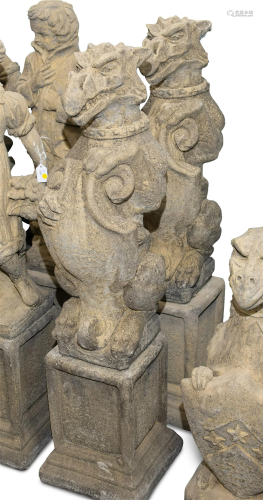 A PAIR OF RECONSTITUTED STONE HERALDIC GRIFFINS, each sittin...