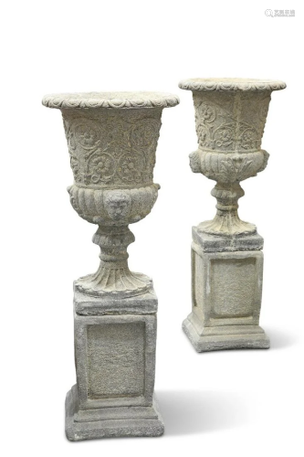 A PAIR OF RECONSTITUTED STONE GARDEN URNS, the bodies with s...