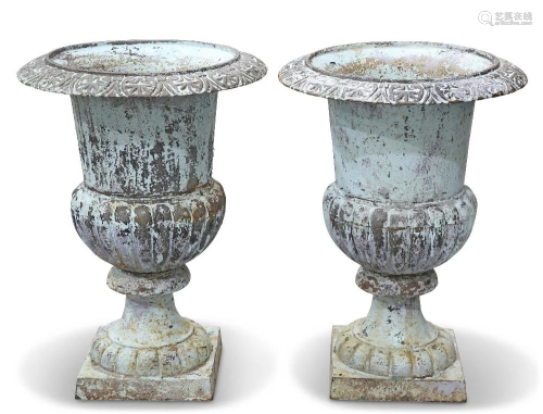 A PAIR OF CAST IRON GARDEN URNS, each with part-fluted body ...