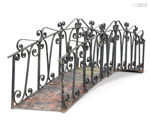 A WROUGHT IRON FOOT BRIDGE, the arched base with scrolling i...
