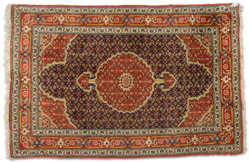 AN AFGHAN HERAT RUG, hand-knotted, the dark blue field with ...
