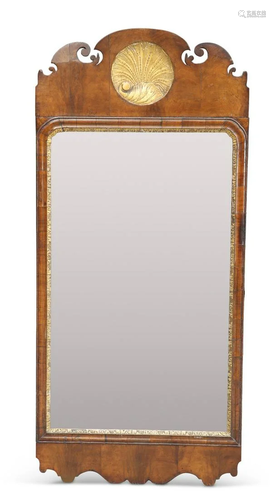 A GEORGE II-STYLE PARCEL-GILT WALNUT FRETWORK MIRROR, the cr...