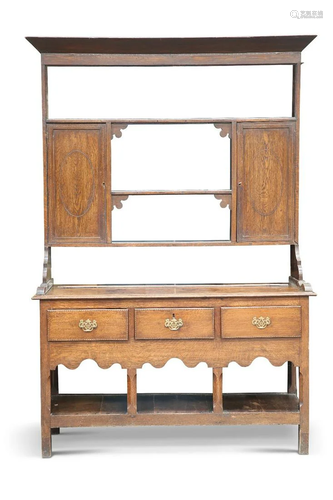 A GEORGE III OAK DRESSER, the base with moulded top over thr...