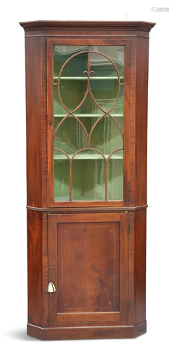 A GEORGE III MAHOGANY FLOOR-STANDING CORNER CABINET, the gla...