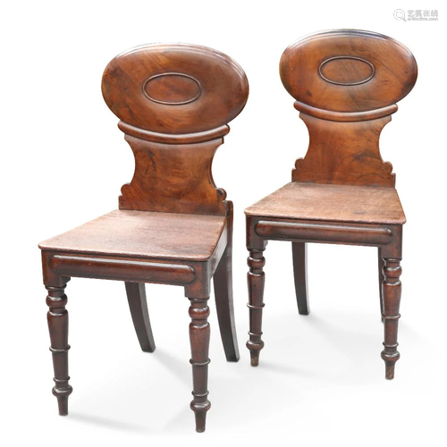 A PAIR OF REGENCY MAHOGANY HALL CHAIRS, the balloon-shaped b...