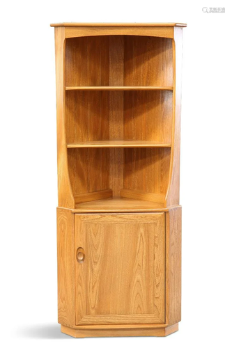 AN ERCOL LIGHT ELM FLOOR-STANDING CORNER CABINET, with fixed...