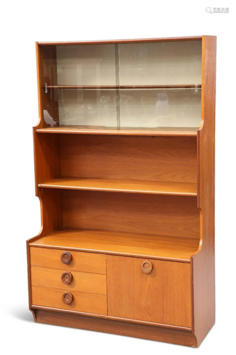 A 1970S TEAK WALL UNIT, with sliding glass doors, cupboard a...