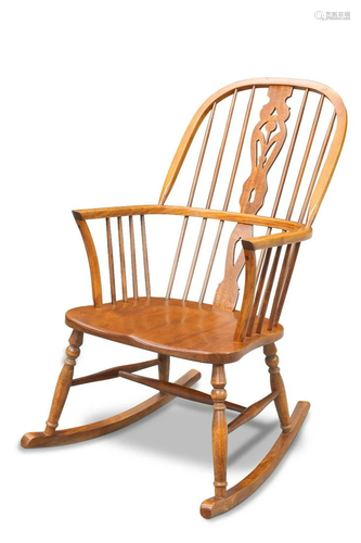 A CRYER CRAFT ELM WINDSOR ROCKING CHAIR, the arched toprail ...