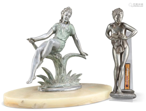 AN ART DECO STYLE METAL FIGURE, the young lady cast reclinin...