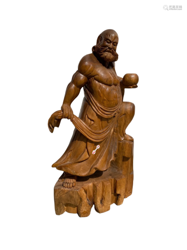 A Carved Wooden DaMo Statue