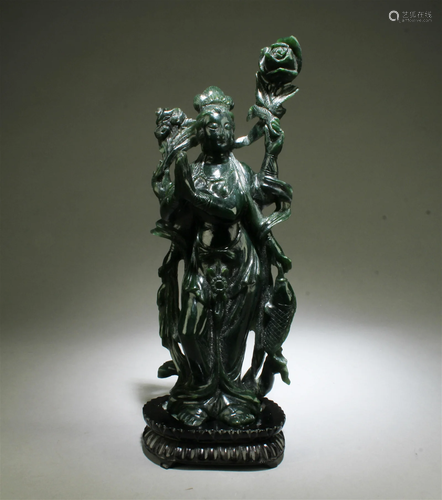 A Carved Spinach Green Guanyin Statue