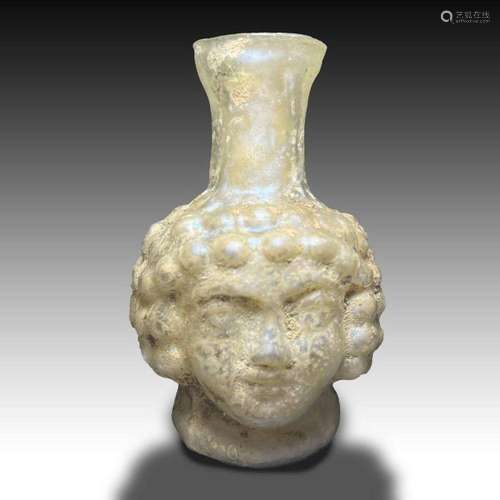 A ROMAN GLASS DOUBLE EROS HEAD FLASK Circa 3rd Century A.D. ...