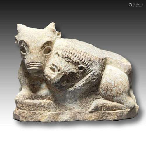 AN ACHAEMENID LIMESTONE FIGURE OF A LION FIGHTING A BULL, CI...