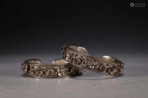 TWO CHINESE SILVER BANGLES CAST WITH 'PRUNUS'