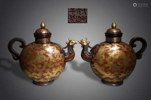 TWO CHINESE PARCEL-GILT-BRONZE EWERS DEPICTING 'DRAGON A...