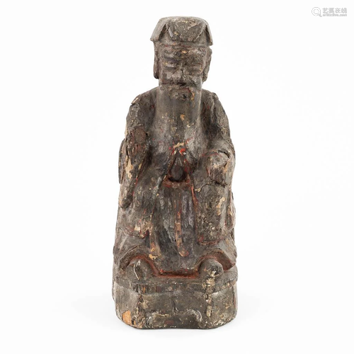 A small and antique wood sculptured statue of a Chinese figu...