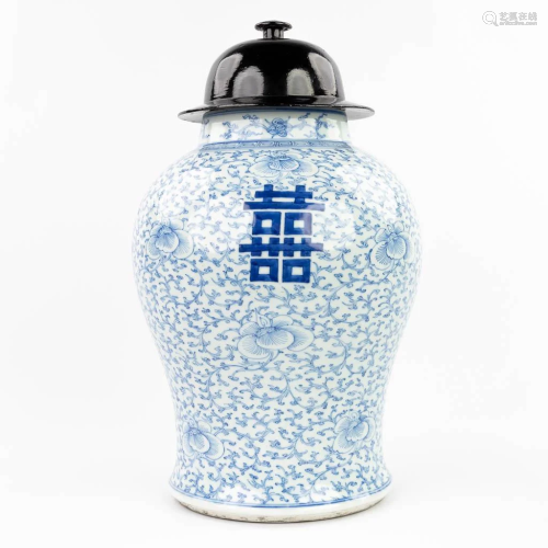 A Chinese Baluster vase with a wood lid made of blue-white p...