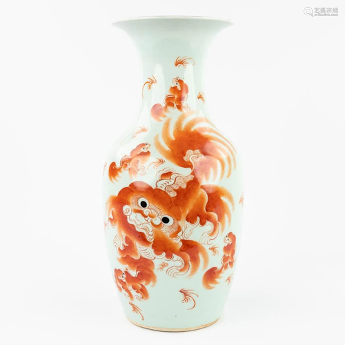 A Chinese vase made of porcelain and decorated with a red fo...