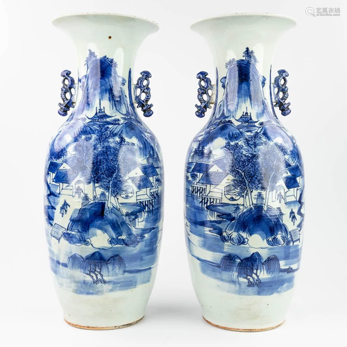 A pair of Chinese vases with blue and white decor of a mount...