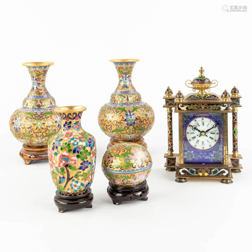 A collection of 4 vases and a small table clock, made of clo...