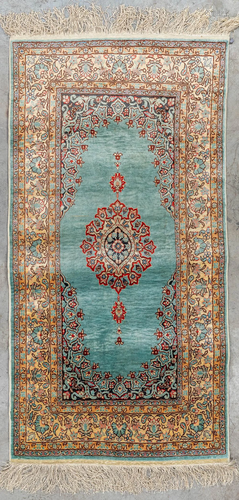 An Oriental hand-made carpet, made of silk. (121 x 61 cm)