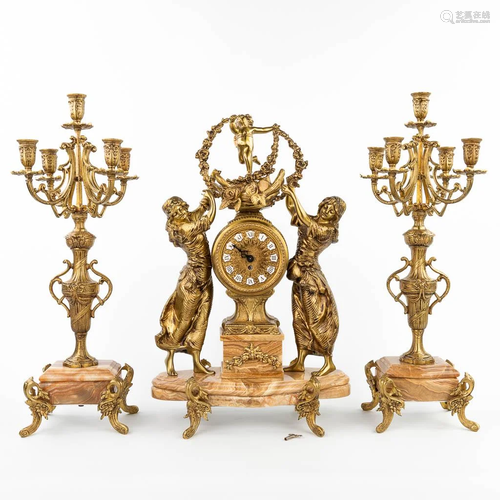 A three-piece mantle garniture clock and candelabra (23 x 37...