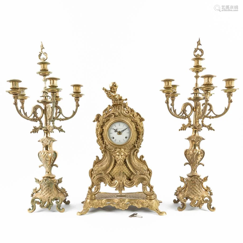 A three-piece mantle garniture clock and candelabra (18 x 34...