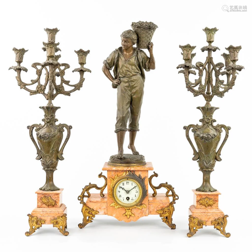 A three-piece mantle garniture clock and candelabra. (15,5 x...