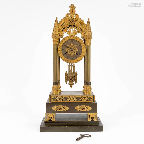 A table column clock made of gilt bronze in a gothic revival...