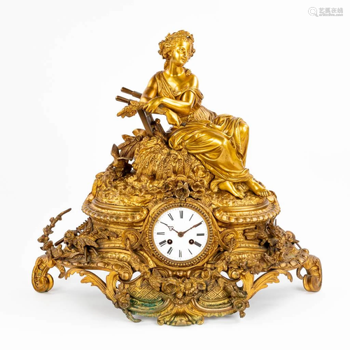 A mantle clock 'The Harvest' with an image of a re...