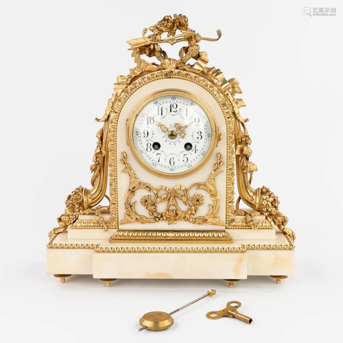 A table clock made of white marble mounted with gold-plated ...