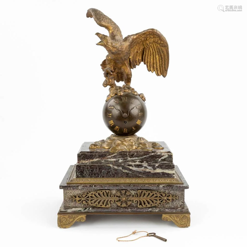 A mantle clock made of marble mounted with patinated bronze ...